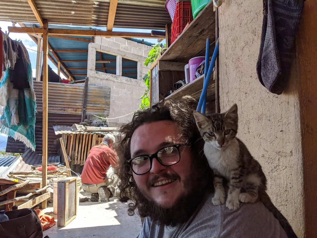J. Wayne Graves Jr. smiling with a cat on his shoulder